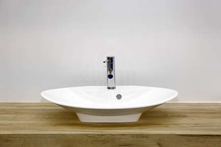 Ceramic Wash Basin at Wooden Counter in Contemporary Bathroomの写真素材