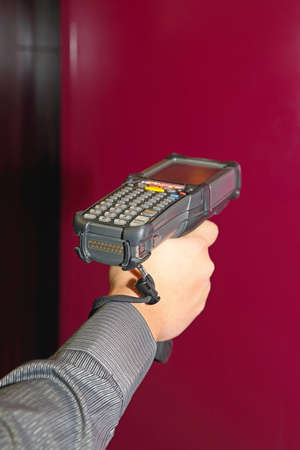 Shipping Worker Holding Handheld Barcode Scanner
