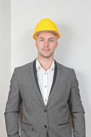 Young Businessman in Gray Suit with Yellow Hard Hat