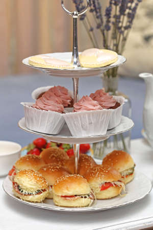 Cakes and Sandwiches at Tiered Tray at Table