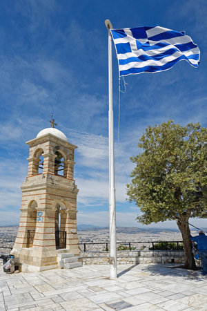 ATHENS, GREECE - MAY 02: Greek Symbols at Mount Lycabettus in Athens on MAY 02, 2015. Greek Flag Bell Tower and Olive Tree at Top of Mount Lycabettos in Athens, Greece.のeditorial素材