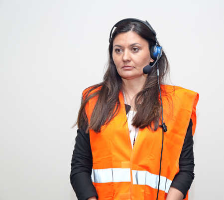 Woman Worker With Wired Headset and Safety West