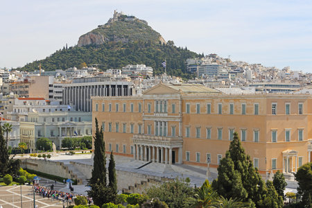 ATHENS, GREECE - MAY 02: Greek Parliament in Athens on MAY 02, 2015. Bunch of Tourists in front of Hellenic Parliament Building and Mount Lycabettus in Athens, Greece.のeditorial素材