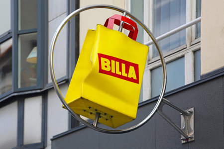 VIENNA, AUSTRIA - JULY 12: Supermarket Billa Sign in Wien on JULY 12, 2015. Rotating Yellow Bag Sign of Austrian Grocery Billa in Vienna, Austria.のeditorial素材