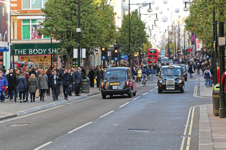 LONDON, UNITED KINGDOM - NOVEMBER 23: Oxford Street in London on NOVEMBER 23, 2013. Oxford High Street Crowded With Shoppers in London, United Kingdom.のeditorial素材