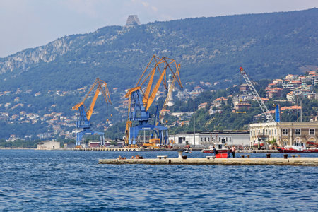 TRIESTE, ITALY - JULY 15: Cranes at Port of Trieste on JULY 15, 2013. Docks and Cranes at Harbour in Trieste, Italy.のeditorial素材