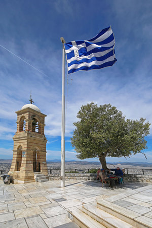 ATHENS, GREECE - MAY 02: Greek Symbols at Mount Lycabettus in Athens on MAY 02, 2015. Greek Flag Bell Tower and Olive Tree at Top of Mount Lycabettos in Athens, Greece.のeditorial素材