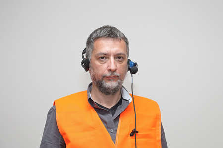 Senior Worker With Safety West and Voice Control Headsetの写真素材