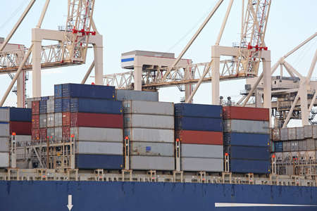 Three Pier Side Gantry Cranes Tower Over Container Ship