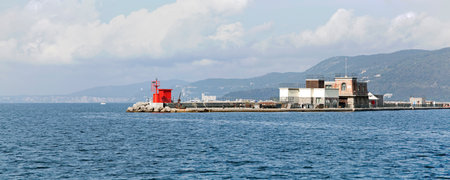Lighthouse and Restaurant at Breakwater Molo Foraneo in Trieste Portのeditorial素材