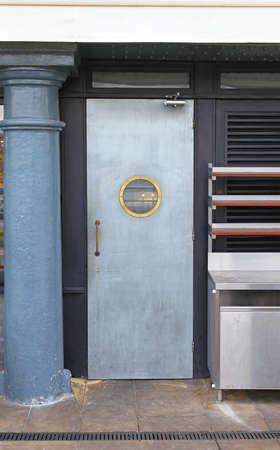 Silver Metal Door With Small Round Windowの写真素材