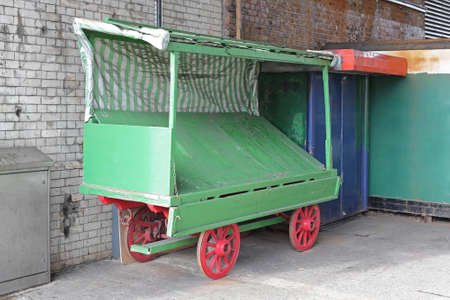 Empty Green Vendor Cart With Red Wheelsの写真素材
