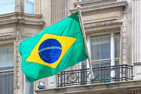 National Brazil Flag at Building Windowの写真素材