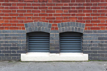 Two Ventilation Inlets at Brick Building Exterior