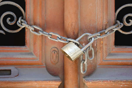 Locked padlock with hain at door