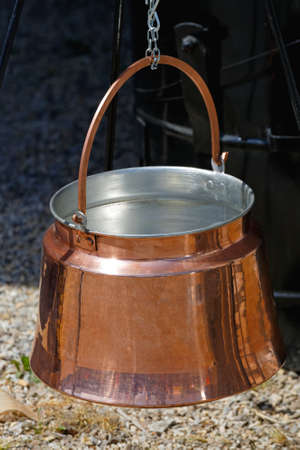 Hanging Copper Pot for Cooking at Open Flameの写真素材