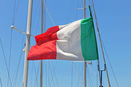 Italian flag flying at yacht mast