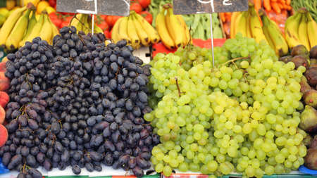 Big Piles of White and Red Grapes at Market