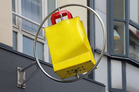 Big Yellow Shopping Bag Rotating Signの写真素材