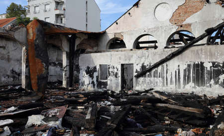 Collapsed Roof and Burned Wooden Beams in Factory After Fireの写真素材