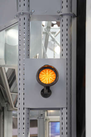 Yellow Safety Light at Metal Columns in Factory