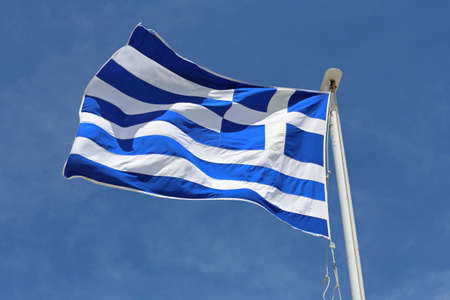 Flag of Greece Flying at Wind over Blue Sky