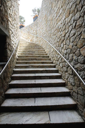 Flight of Stairs With Banister and Stone Wallの写真素材