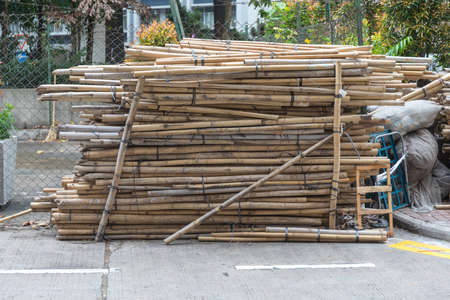 Big Stacks of Bamboo Sticks Poles at Construction Siteの写真素材