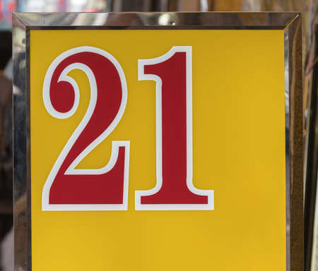 Red Twenty One Numbers at Yellow Foil Sign