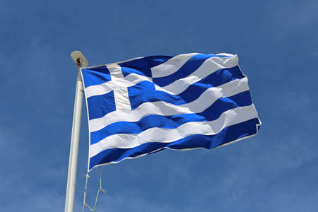 Flag of Greece Flying at Wind Over Blue Sky