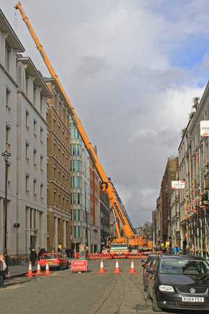 London, United Kingdom - April 02, 2010: Mobile Crane Construction Works at Closed Street in London, UK.のeditorial素材