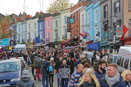 London, United Kingdom - November 23, 2013: Bunch of Tourists and Colorful Houses at Portobello Road Saturday in London, UK.のeditorial素材