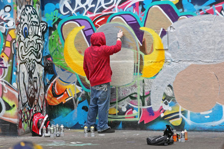 London, United Kingdom - January 26, 2013: Young Graffiti Artist Vandal Spraying Walls With Paint in London, UK.のeditorial素材