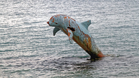 Bijela, Montenegro - April 17, 2011: Rusty Dolphin Forgoten and Abandoned Delfin Sculpture in...
