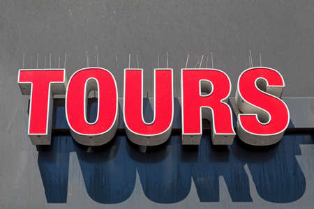 Big Red Letters Tours Sign at Building Wallの写真素材