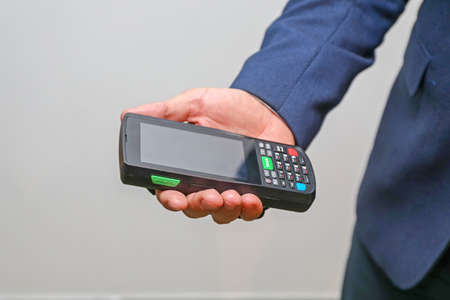 Man Holding Handheld Barcode Scanner Reader Portable Computerの写真素材