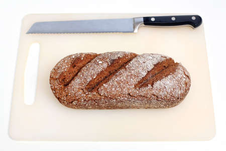 Rye Bread and Knife at Plastic Cutting Board