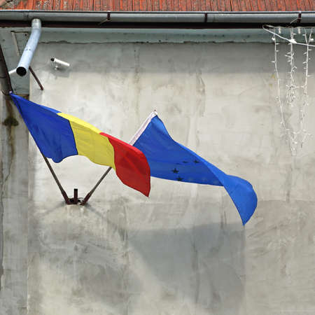 European and Romanian Flags at Building