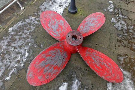 Big Red Propeller With Four Blades at Street Pavementの写真素材