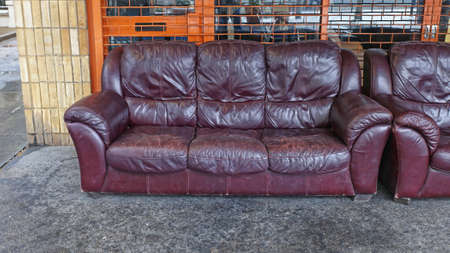 Rejected Old Leather Sofa in Front of Shop