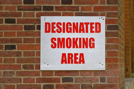 Designated Smoking Area Sign at Building Cornerの写真素材