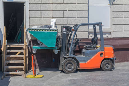 Forklift Truck With Skip Container at Construction Site