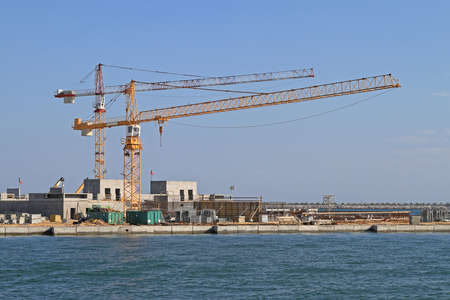 Construction Cranes at Seawall Protection in Venetian Lagoon