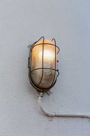 Old Incandescent Lamp Fixture at Ship Outdoor Wall