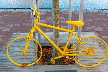 Painted Bright Yellow Bicycle in Fredristad Norwayの写真素材