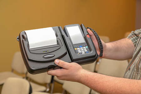 Man Holding Mobile Barcode Printer and Scanner Set Device