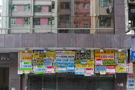 Kowloon, Hong Kong - May 01, 2017: Store Front Covered With Telephones Posters in Kowloon, Hong Kong.のeditorial素材