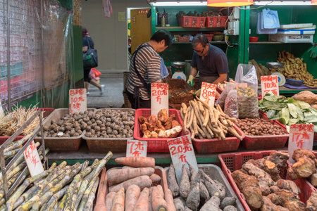 KOWLOON, HONG KONG - APRIL 22, 2017: Potatoes and Roots Vegetables at Market Stall Mong Kok in Kowloon, Hong Kong.のeditorial素材