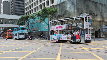 Hong Kong - April 23, 2017: Double Decker Tram in Frount of Louis Vuitton Shop in Hong Kong, China.のeditorial素材