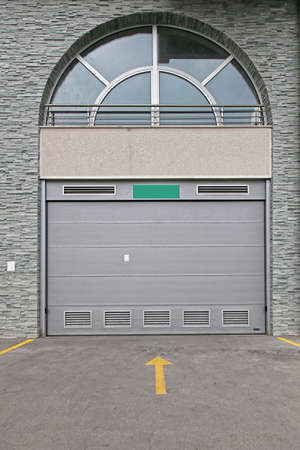 Closed Grey Garage  Door Car Entrance With Arch